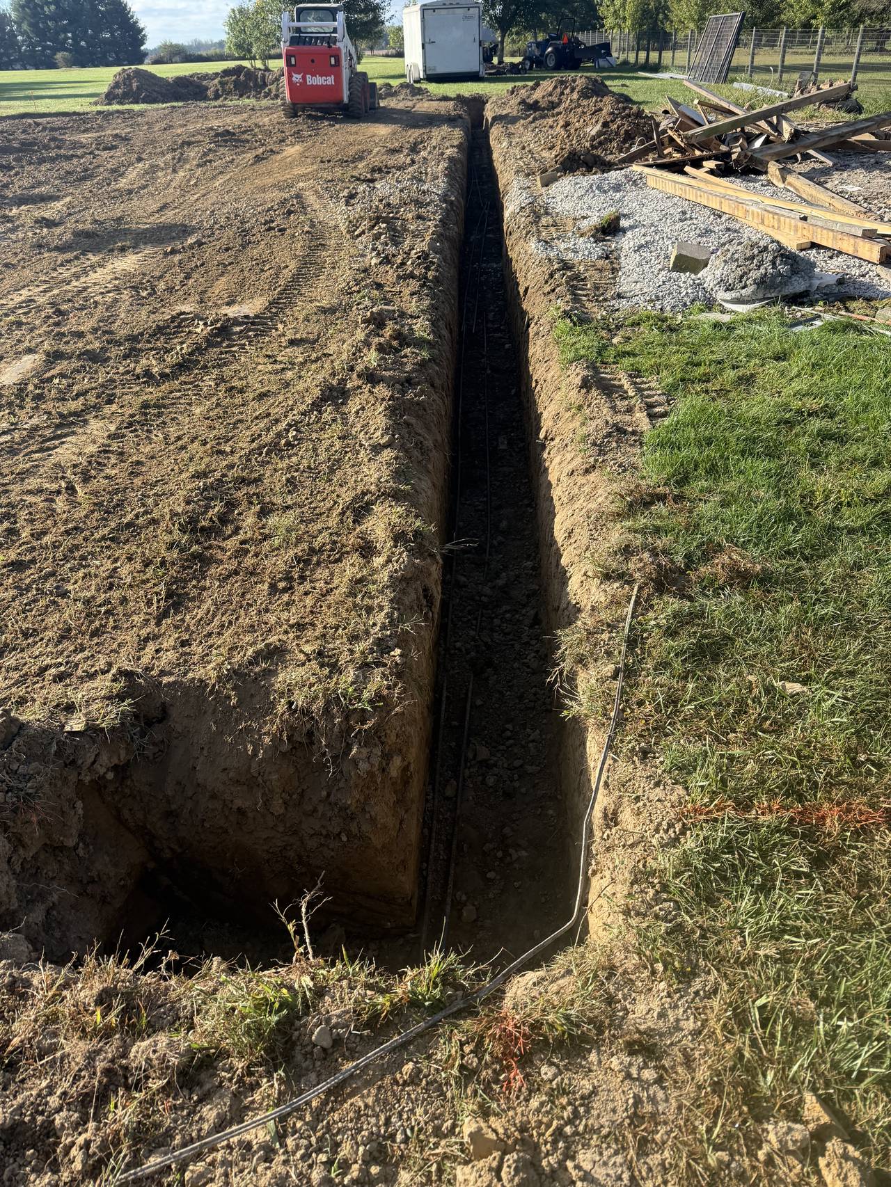 Trench and continuous footing preparation for a pole barn slab