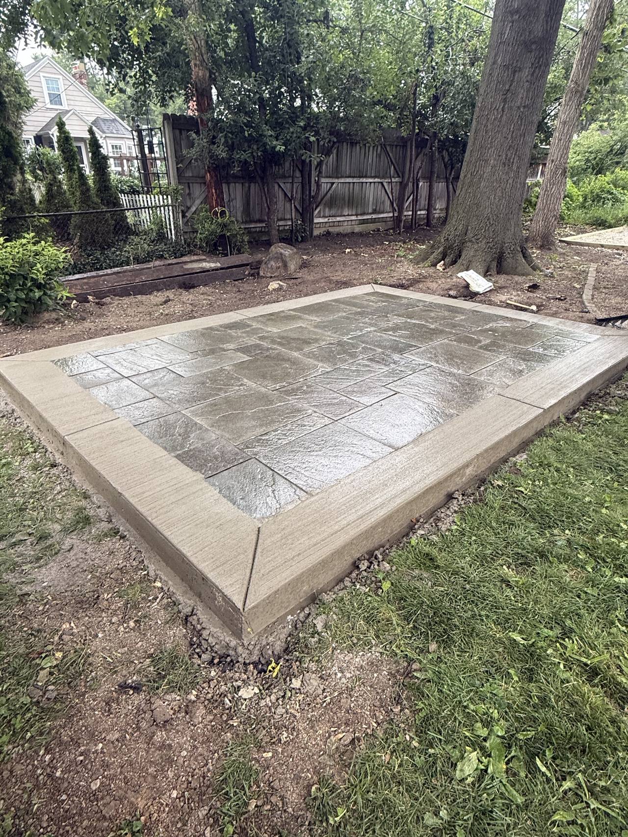 Stamped concrete patio in a backyard